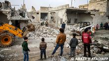 Members of the Syrian Civil Defence (also known as The White Helmets), use a bulldozer to remove debris from buildings which were damaged by reported air strikes in the rebel-held town of Orum al-Kubra, in the northern Syrian province of Aleppo, on January 5, 2019. - Airstrikes by Syrian regime ally Russia hit the west of Aleppo province late on January 4, the first such raids in the area since a deal between Moscow and rebel backer Ankara to stave off a massive regime offensive on the wider Idlib region in September 2018. (Photo by Aaref WATAD / AFP)