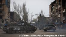 Russian military vehicles move in an area controlled by Russian-backed separatist forces in Mariupol, Ukraine, Saturday, April 23, 2022. (AP Photo/Alexei Alexandrov)