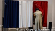 27.6.2021****TOPSHOT - Voters enter a polling booth equipped with anti-covid curtains at a polling station in Le Touquet, for the second round of the French regional elections on June 27, 2021. (Photo by Ludovic MARIN / POOL / AFP) (Photo by LUDOVIC MARIN/POOL/AFP via Getty Images)
