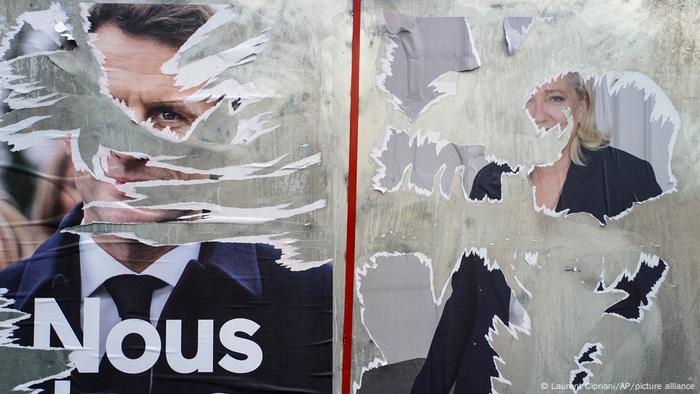 Scratched and torn election posters from the Macron and Le Pen campaigns