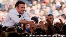 22.4.2022, Figeac****TOPSHOT - French President and centrist La Republique en Marche (LREM) party candidate for re-election Emmanuel Macron shakes hands with supporters as he holds a rally on the last day of campaigning, in Figeac, southern France, on April 22, 2022, ahead of the second round of France's presidential election. - Macron faces the French far-right Rassemblement National (RN) party candidate in a run-off vote on April 24, 2022. (Photo by Ludovic MARIN / AFP) (Photo by LUDOVIC MARIN/AFP via Getty Images)