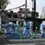 上海黃浦區的幾名衛生部門職員正在準備噴灑消毒劑 