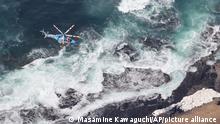24.4.2022***An aerial photo shows a search in Shari Town, Hokkaido Prefecture on April 24, 2022. The Japan Coast Guard said on the same day that it found more than ten people on the sea and on rocks around the tip of Cape Shiretoko, where a sightseeing boat with 26 people aboard went missing after issuing emergency calls on a previous day. ( The Yomiuri Shimbun via AP Images )