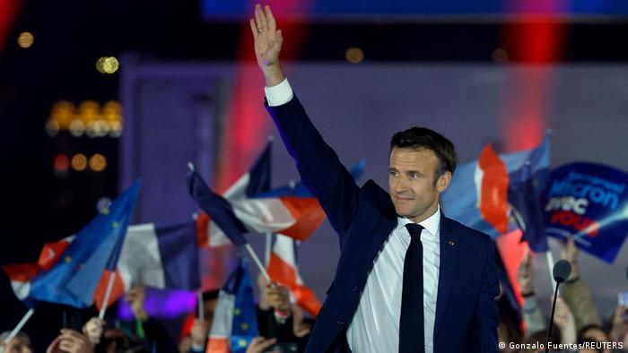 Macron waves to the crowd at his victory speech