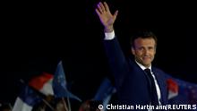 French President Emmanuel Macron waves as he arrives to deliver a speech after being re-elected as president, following the results in the second round of the 2022 French presidential election, during his victory rally at the Champs de Mars in Paris, France, April 24, 2022. REUTERS/Christian Hartmann