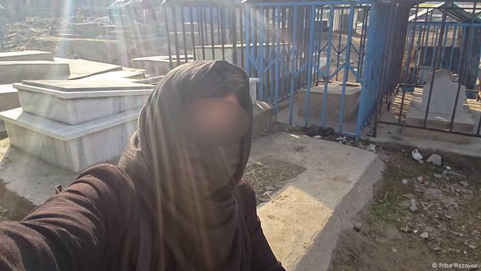 Amira (name changed) hides from the Taliban in a cemetery