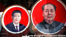 FILE - In this March 1, 2016 file photo, souvenir plates bearing images of Chinese President Xi Jinping, left, and late Chinese leader Mao Zedong are displayed at a shop near Tiananmen Square in Beijing. In 2016, the Chinese Communist Party bestows on Xi the wholly ceremonial yet highly significant title of core of the fifth generation of Chinese leaders. That elevates Xi in status above Hu, whose China Youth League faction Xi is rapidly dismantling, leaving the increasingly marginalized Premier Li Keqiang as Hu's sole remaining ally in the Politburo Standing Committee.(AP Photo/Andy Wong, File)