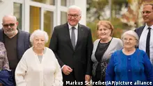 German President Frank-Walter Steinmeier, center, poses with Holocaust survivors fleeing the war in their home land Ukraine, after a meeting at an eldery's home in Berlin, Germany, Monday, April 25, 2022. From left: Alexander Sulkovskiy, Susana Neyman, President Frank-Walter Steinmeier, Lila Vaksman, Swetlana Sabudkina and a representative of the Jewish Claims Conference Ruediger Mahlo. (AP Photo/Markus Schreiber, Pool)