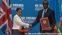 14.04.2022
British Home Secretary Priti Patel (L), and Rwandan Minister of Foreign Affairs and International Cooperation Vincent Biruta, shake hands after signing an agreement at Kigali Convention Center, Kigali, Rwanda on April 14, 2022. - An agreement was finally announced Thursday with Rwanda, where British Home Secretary Priti Patel visited. Asylum seekers arriving in the UK will be sent to Rwanda, under a controversial deal announced Thursday with which Boris Johnson's government hopes to deter record-breaking illegal Channel crossings. London will initially finance the device to the tune of 120 million pounds sterling (144 million euros). (Photo by Simon WOHLFAHRT / AFP) (Photo by SIMON WOHLFAHRT/AFP via Getty Images)