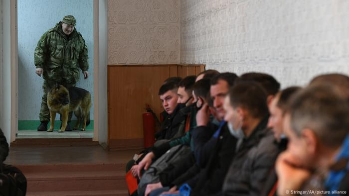 A row of men awaiting registration 