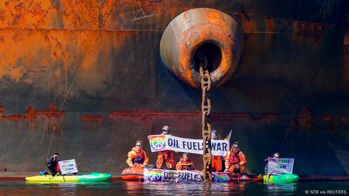 Members of Greenpeace sail next to a Russian tanker as part of a protest against delivering Russian oil to Norway.