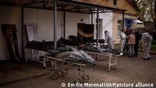 Dead bodies wait to be identified outside a morgue in Bucha, on the outskirts of Kyiv, Monday, April 25, 2022. (AP Photo/Emilio Morenatti)