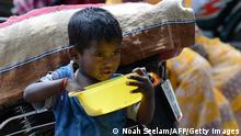 An Indian child eats from a bowl on a street in the Vaddera Basthi slum in Hyderabad on July 13, 2016.
More than one third of India's 62 million children aged five or less are stunted in their growth, according to a global report. World Bank President Jim Yong Kim warned during a visit to India in June that if you walk into the future economy with 40 percent of your workforce having been stunted as children, you are simply not going to be able to compete. / AFP / NOAH SEELAM (Photo credit should read NOAH SEELAM/AFP via Getty Images)