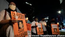 Activists holds posters against the impending execution of Nagaenthran K. Dharmalingam, sentenced to death for trafficking heroin into Singapore, during a candlelight vigil gathering outside the Singaporean Embassy in Kuala Lumpur, Malaysia, Tuesday, April 26, 2022. The Singapore Court of Appeal has dismissed a last-minute legal challenge filed by the mother of a mentally disabled Malaysian man in an attempt to halt his execution for drug trafficking. (AP Photo/Vincent Thian)