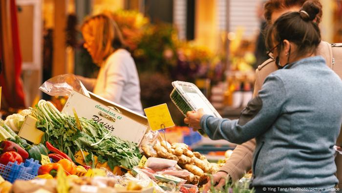 Shoppers are seen at a vegetable stall at Carlstadt in Duesseldorf, Germany