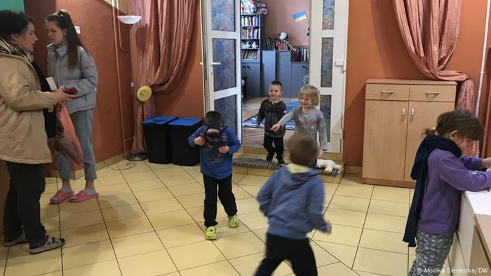 Young children play inside the home in Lodz