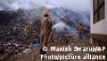 Fire officials try to douse a fire at the Bhalswa landfill in New Delhi, India