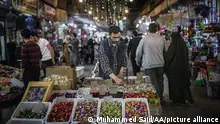 IDLIB, SYRIA - APRIL 27: Sellers await customers as people go shopping ahead of the Eid al-Fitr holiday that marks the end of the Muslim holy fasting month of Ramadan in Idlib, Syria on April 27, 2022. Muhammed Said / Anadolu Agency
