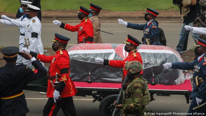 A military honor guard walks with the coffin of former Kenyan President Mwai Kibaki, at his state funeral in the capital, Nairobi, Friday, April 29, 2022. 
