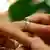 wedding ring being put on a finger