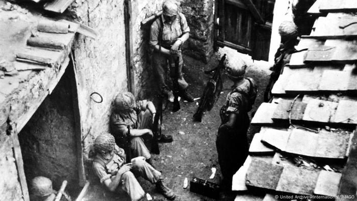 In this April 1944 file photo, German paratroopers wait in the yard of a country house for orders to counter attack, near Cassino, Italy