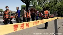 People queue for a swab test for the Covid-19 coronavirus near the entrance of the Forbidden City in Beijing on May 1, 2022. (Photo by Noel Celis / AFP) (Photo by NOEL CELIS/AFP via Getty Images)