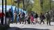 Civilians who left the area near Azovstal steel plant in Mariupol walk accompanied by UN staff at a temporary accommodation center Civilians who left the area near Azovstal steel plant in Mariupol walk accompanied by UN staff at a temporary accommodation center