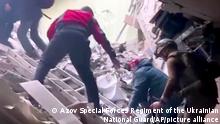 This frame taken from an undated video provided Sunday, May 1, 2022 by the Azov Special Forces Regiment of the Ukrainian National Guard shows people climbing over debris at the Azovstal steel plant, in Mariupol, eastern Ukraine. As many as 100,000 people may still be in Mariupol, including an estimated 2,000 Ukrainian fighters beneath the sprawling, Soviet-era steel plant â€” the only part of the city not occupied by the Russians. (Azov Special Forces Regiment of the Ukrainian National Guard via AP)