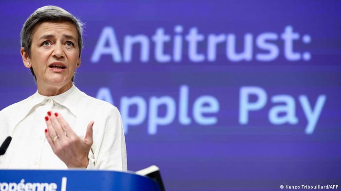 European Competitor Commissioner Margrethe Vestager gestures in front of the words Antitrust: Apple Pay at a press conference