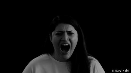Afghan Sara Nabil in a black-and-white image, screaming into the camera.