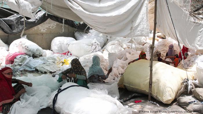 Women working in piles of cloth