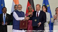 German Chancellor Olaf Scholz (C-R) and Indian Prime Minister Narendra Modi (C-L) shake hands after signing an agreement during Indo-German governmental consultations at the Chancellery in Berlin on May 2, 2022. (Photo by John MACDOUGALL / AFP) (Photo by JOHN MACDOUGALL/AFP via Getty Images)