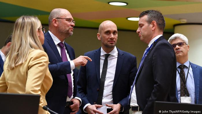 European politicians (Slovakia's Richard Sulik [l] and Hungary's Attila Steiner [r]) discussing with one another during a crisis meeting in Brussels