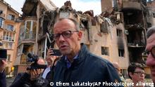 The Chairman of the German Christian Democratic Party (CDU) Friedrich Merz walks surrounded by media in Irpin, Ukraine, Tuesday, May 3, 2022. (AP Photo/Efrem Lukatsky)