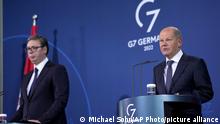 German Chancellor Olaf Scholz, right, and Serbian President Aleksandar Vucic, left, address the media during a joint press conference after a meeting at the Chancellery in Berlin, Germany, Wednesday, May 4, 2022. (AP Photo/Michael Sohn)