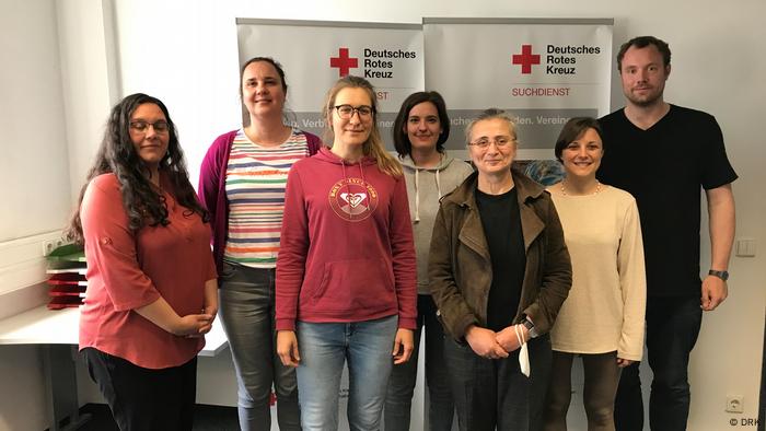 Munich team posing for photo in their office