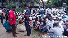 In this picture taken on May 4, 2022, a policeman takes the details of Rohingya refugees who were detained from a beach, at the Sadar Model police station in Cox's Bazar. - Bangladesh police detained at least 450 Rohingya refugees as they celebrated the Muslim festival of Eid on a popular beach, officials said on May 5, 2022. (Photo by Tanbir MIRAJ / AFP)