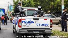 Police officers from a tactical unit patrol the city of San Salvador during a security operation