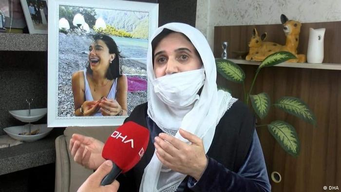 Sefika Gultekin, the mother of Pinar with a photo of her murdered daughter