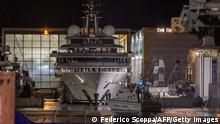 Italy's financial police patrol boat is seen in front of the multi-million-dollar mega yacht Scheherazade, docked at the Tuscan port of Marina di Carrara, Tuscany, on May 6, 2022, after its basin was reflooded. - The mega yacht at the centre of a mystery over its ownership appeared ready to set sail from Italy Friday, as speculation swirls it might belong to the Russian president. Scheherazade, worth an estimated $700 million, is the subject of a probe into its ownership by Italy's financial police. (Photo by Federico SCOPPA / AFP) (Photo by FEDERICO SCOPPA/AFP via Getty Images)