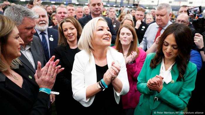 Michelle O'Neill (center) applauds with party colleagues