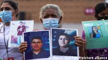 Members of a caravan of Central American mothers hold photos of their missing children during a demonstration at the Zocalo in Mexico City, Saturday, May 7, 2022. The protesters, made up mostly of women from Central America, travel through Mexico to search for their relatives who left for a better life and then disappeared on their way to the U.S. (AP Photo/Marco Ugarte)