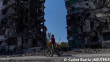 Mykola Ovdienko, 66, looks at a building destroyed by an airstrike, as Russia's attack on Ukraine continues, in the town of Borodianka, Ukraine May 5, 2022. REUTERS/Carlos Barria 