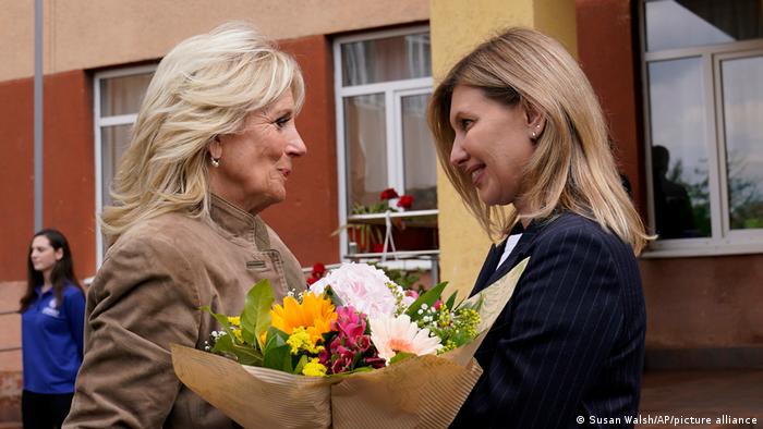First lady Jill Biden receives flowers from Olena Zelenskyy, spouse of Ukrainian's President Volodymyr Zelenskyy