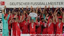 Bayern's players celebrate with the championship trophy after the German Bundesliga soccer match between Bayern Munich and Stuttgart, at the Allianz Arena, in Munich, Germany, Sunday, May 8, 2022. (AP Photo/Michael Probst )