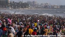 People crowd the Juhu beach on the Arabian Sea coast on a hot and humid day in Mumbai, India, Sunday, May 8, 2022. (AP Photo/Rafiq Maqbool)
