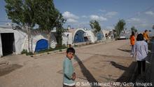 Displaced Yazidis stand by their tents at the Chamishko camp for internally displaced persons (IDP) in the city of Zakho in the north of Iraq's autonomous Kurdish region on May 5, 2022. - Thousands of Yazidis were again forced to flee their homes this month, after fierce clashes between the army and local fighters in their Sinjar heartland. (Photo by SAFIN HAMED / AFP) (Photo by SAFIN HAMED/AFP via Getty Images)
