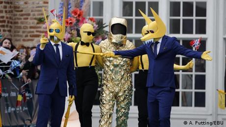 A group of people wearing yellow alien costumes.