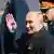 Putin waving in Moscow next to a military officer