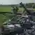 Українські військові біля збитого російського вертольота на Харківщині в травні